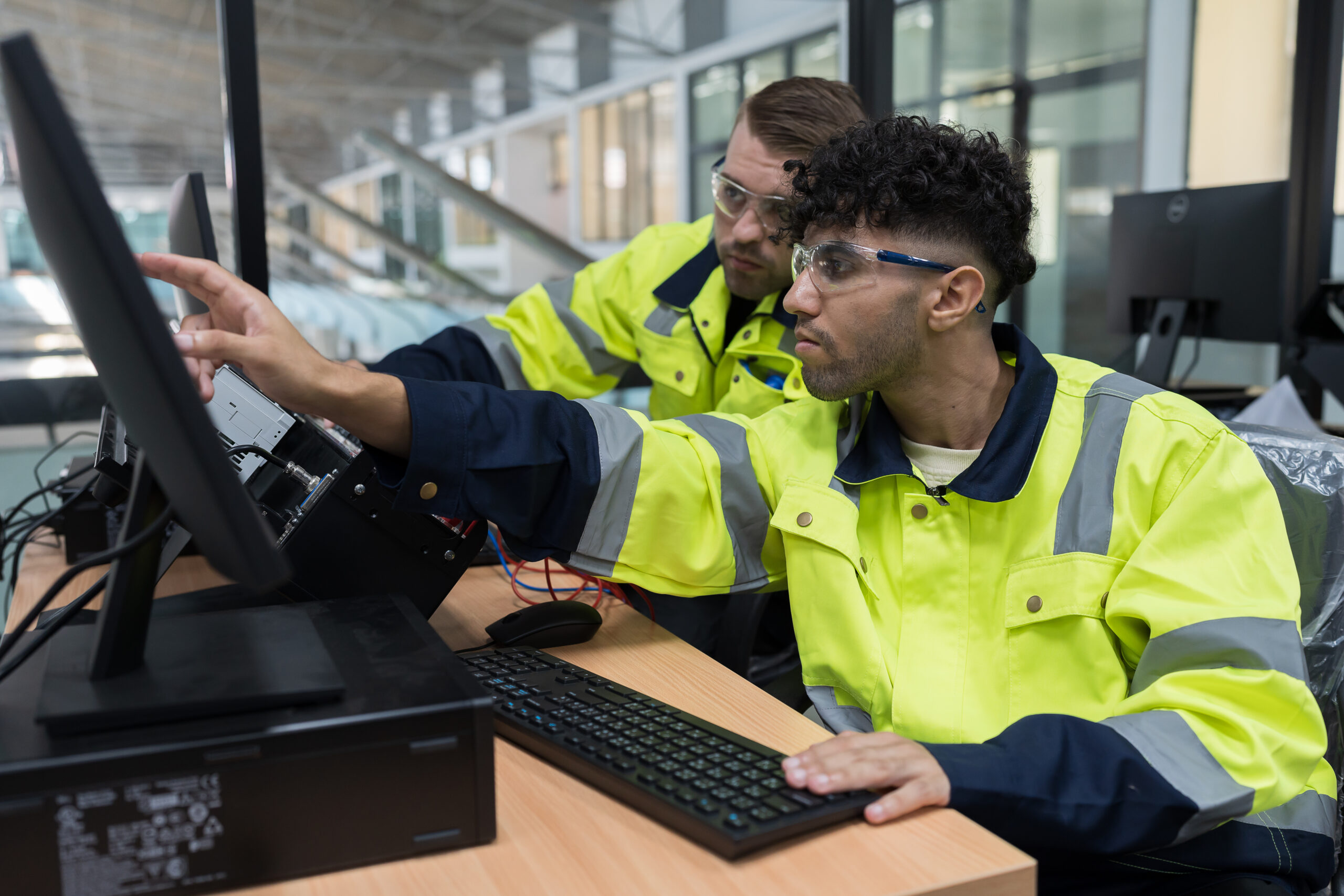 Electrical engineers training on an industrial control system